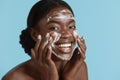 Black girl wash face with cleansing face foam