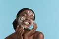 Black girl wash face with cleansing face foam Royalty Free Stock Photo