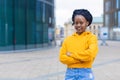 Black girl, young smiling african american woman, beautiful afro lady in casual  yellow trendy clothes with crossed hands Royalty Free Stock Photo