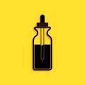 Black Glass bottle with a pipette. Vial with a pipette inside and lid icon isolated on yellow background. Container for medical Royalty Free Stock Photo