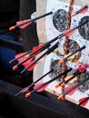 Black glass fibre archery crossbow bolts with plastic colour vanes on house-made practice target in private backyard garden