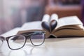 Black glasses on the background of the book Royalty Free Stock Photo