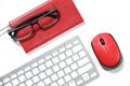 Black glasses on a red notebook, red mouse and white keyboard isolated on a white Royalty Free Stock Photo