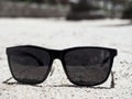 Black glasses on the sand on the beach of Hurghada