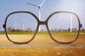 Black glasses with wind wheels in the background Royalty Free Stock Photo