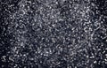 Black Christmas glitter sparkle background. Black friday shiny pattern with sequins Royalty Free Stock Photo