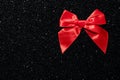 Black glitter texture red satin bow background