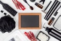 Black glossy cosmetic accessories for body and skin care with red sprig and blank brown photo frame on soft light white wooden. Royalty Free Stock Photo