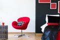 Multifunctional bedroom with red chair Royalty Free Stock Photo