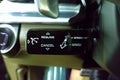 Black glossy Cruise control selector switch under the steering wheel of premium car Royalty Free Stock Photo