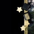 Black and gold christmas gifts with foil stars on dark background