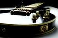Black and gold colored electric guitar - close up
