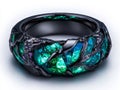 A black gold ring with green and blue stones Royalty Free Stock Photo