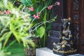 Black and gold statuette of a Hindu deity in Ubud garden in Bali