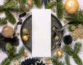 Black and golden Christmas Table setting with ornaments and fir tree branches. Menu card Mockup Royalty Free Stock Photo