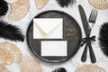 Black and golden wedding table setting with a blank card and envelope top view, mockup Royalty Free Stock Photo