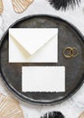 Black and golden wedding table setting with a blank card and envelope top view, mockup Royalty Free Stock Photo