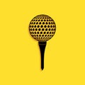 Black Golf ball on tee icon isolated on yellow background. Long shadow style. Vector