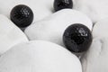 Black golf balls and white stones Royalty Free Stock Photo