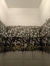 black graffiti pattern inside a dirty bathroom in a bar Royalty Free Stock Photo