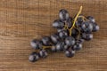 Fresh raw black grape on brown wood