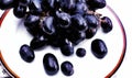 These are black grapes. Arranged on white plate. Royalty Free Stock Photo