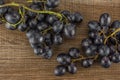 Fresh raw black grape on brown wood