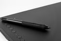 Black graphic tablet with pen for illustrators, designers and photographers, isolated on white background