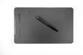 Black graphic tablet with pen for illustrators, designers and photographers, isolated on white background