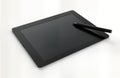Black graphic tablet, stylus. Modern tech tool for digital design, illustration. High-precision input device. Versatile tool for Royalty Free Stock Photo