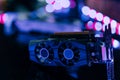 Black graphics card on black table under neon light. Part of computer for gaming and cryptocurrency mining Royalty Free Stock Photo