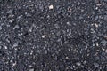 Black and gray asphalt with rocks background texture closup Royalty Free Stock Photo