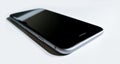 Black-gray mobile phone laying down Royalty Free Stock Photo