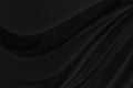 Black gray satin dark fabric texture luxurious shiny that is abstract silk cloth background.