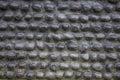 Black gray wall of oval cobble stones masonry. rough surface of the wall. stone pebble texture Royalty Free Stock Photo