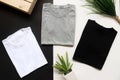 Black , gray , white t-shirts with wood box and cactus. rustic background