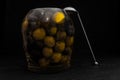 Black and Green Olives in Glass Jar With Metal Spoon Royalty Free Stock Photo