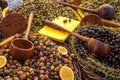 Black and green olives with herbs and wooden spoons on a French market stall. Royalty Free Stock Photo