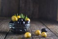 Black and green olives mixed in the bowl on wooden table, organic food, healthy nutrition Royalty Free Stock Photo