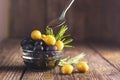 Black and green olives mixed in the bowl on wooden table, spoon with olive oil, vegetarian healthy food concept Royalty Free Stock Photo