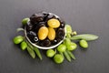 Black and green olives mixed in the porcelain bowl Royalty Free Stock Photo