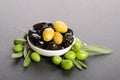 Black and green olives mixed in the porcelain bowl Royalty Free Stock Photo