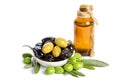 Black and green olives mixed in the porcelain bowl and Virgin olive oil in a crystal bottle on white background Royalty Free Stock Photo