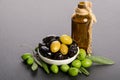Black and green olives mixed in the porcelain bowl and Virgin olive oil Royalty Free Stock Photo