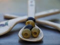 Olives with vintage spoon on dark table close-up