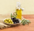 Black and green olives, olive branches and olive oil Royalty Free Stock Photo