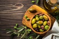 Black and green olives on wooden table. Royalty Free Stock Photo