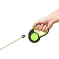 Black and green retractable dog leash on isolated white
