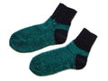 Black and green color striped isolated wool socks on white surface