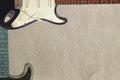 Black and grey electric classic guitars on rough cardboard background, with plenty of copy space. Royalty Free Stock Photo